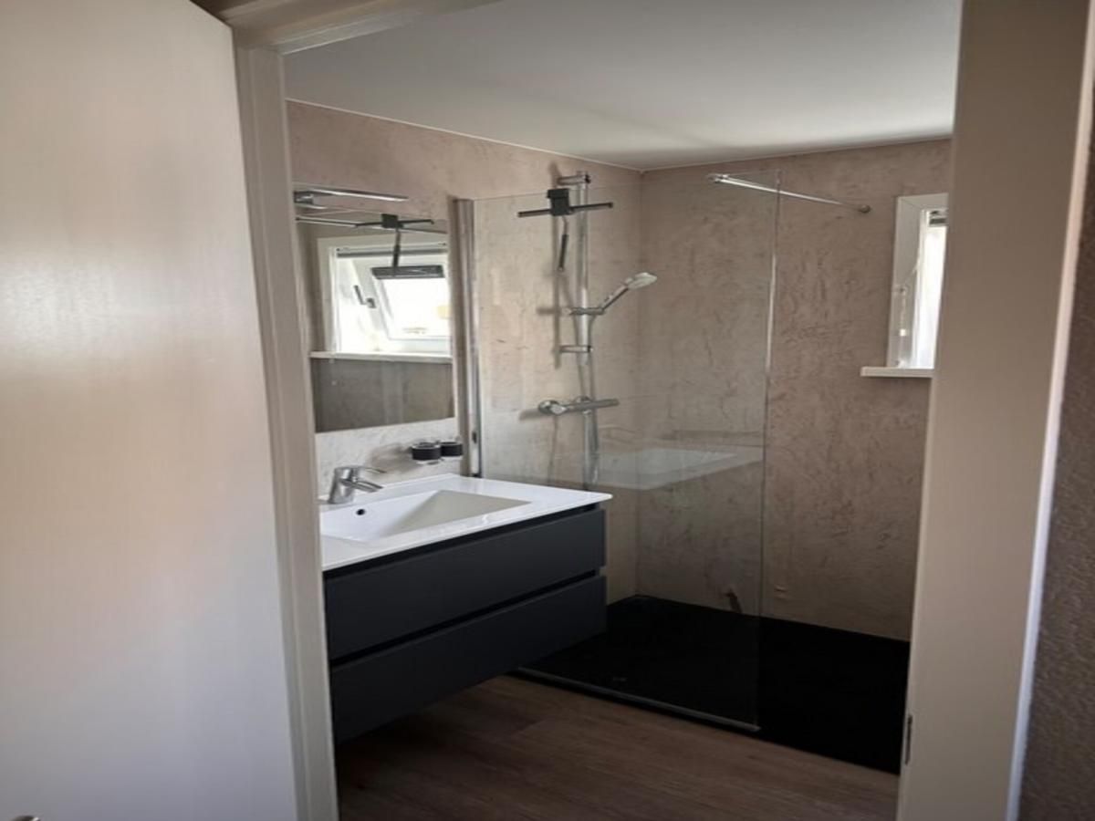 Modernes Badezimmer in der Villa Belle Haan, einem Ferienhaus in De Haan, Westflandern, mit stilvoller Dusche und Waschbecken.