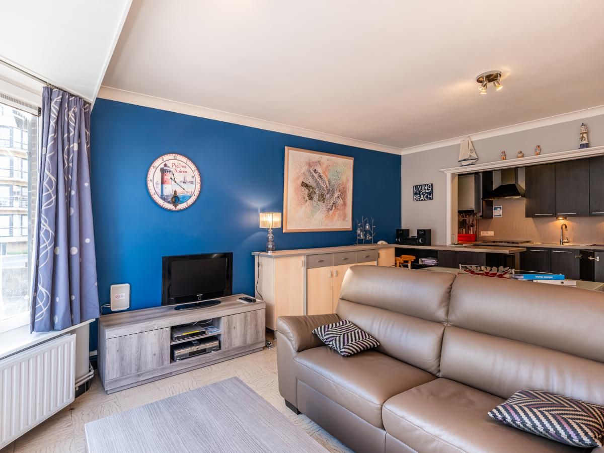 Gezellige woonkamer in Apollo Gelijkvloers vakantiehuis, Koksijde, West-Vlaanderen, met moderne inrichting en comfortabele zithoek.