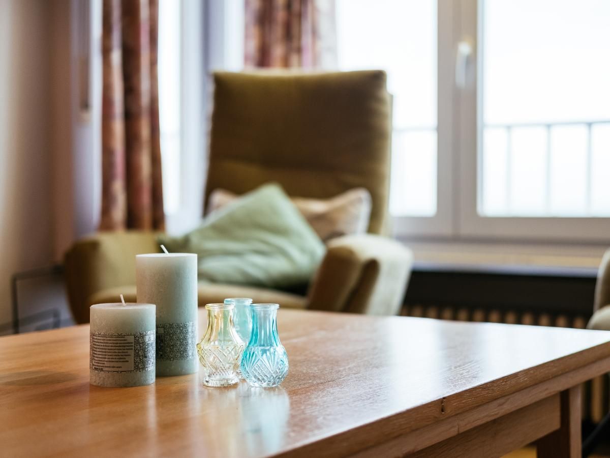 Gezellige woonkamer van Courant du Golfe vakantiehuis in Koksijde, West-Vlaanderen, met comfortabele stoelen en sfeervolle kaarsen.