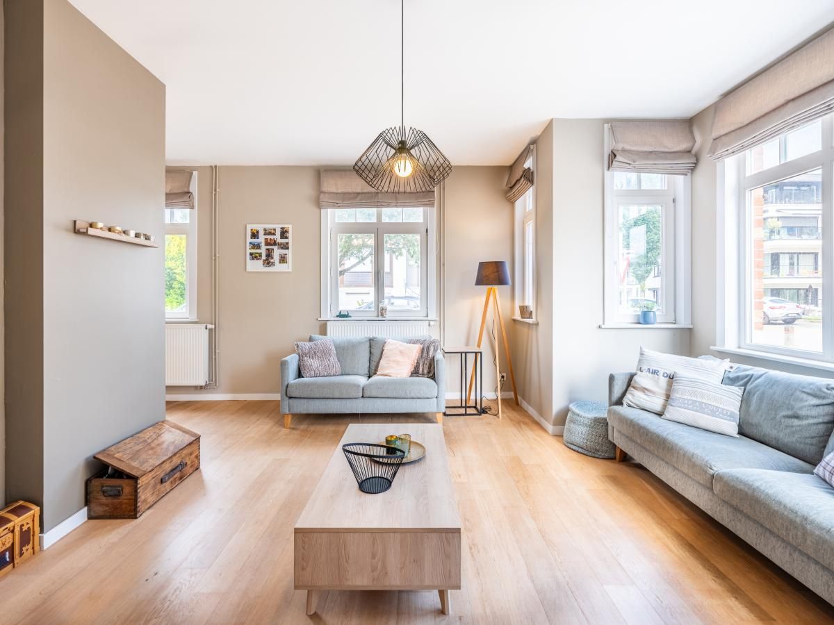 Stylish living room in vacation home Au Coin, Koksijde, West Flanders. Comfortable sitting area with lots of natural light and modern furnishings.