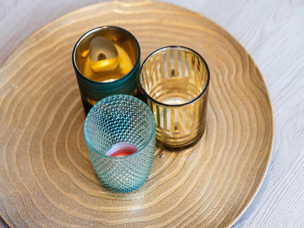 Atmospheric details in vacation home Au Coin in Koksijde, West Flanders, Belgium, with stylish glass decoration on a wooden table.
