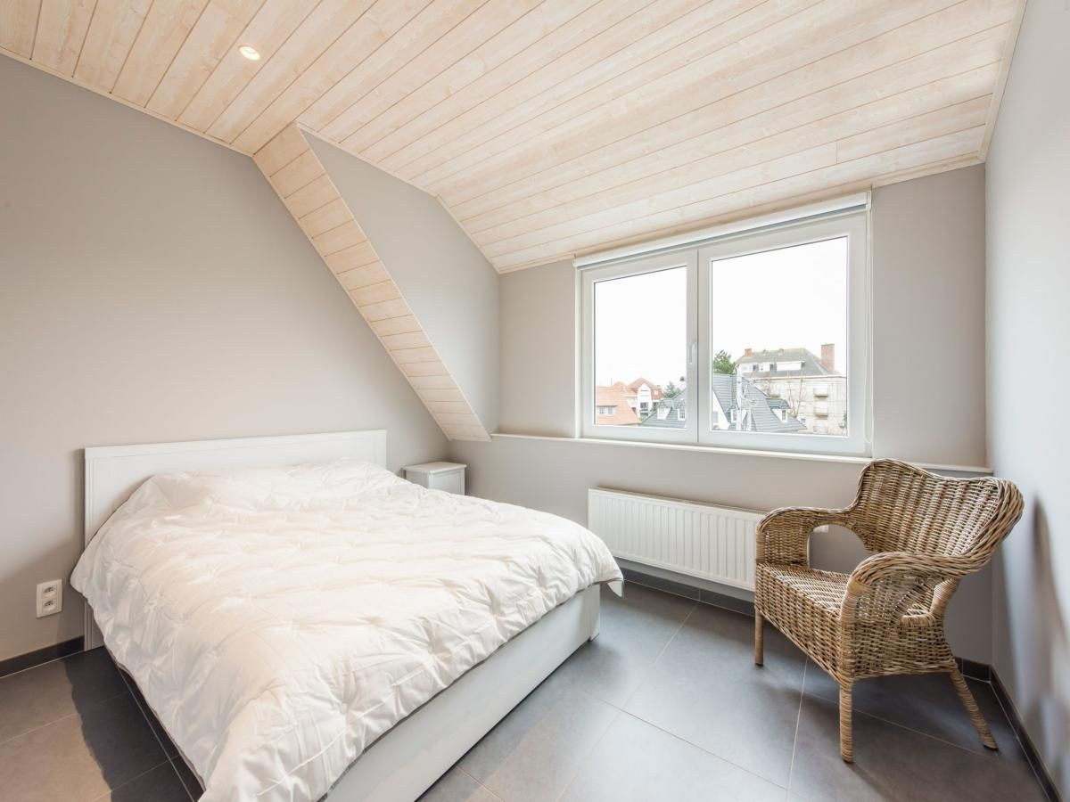 Cozy bedroom in vacation home La Vachequirit, Koksijde, West Flanders, with city views and lots of natural light.