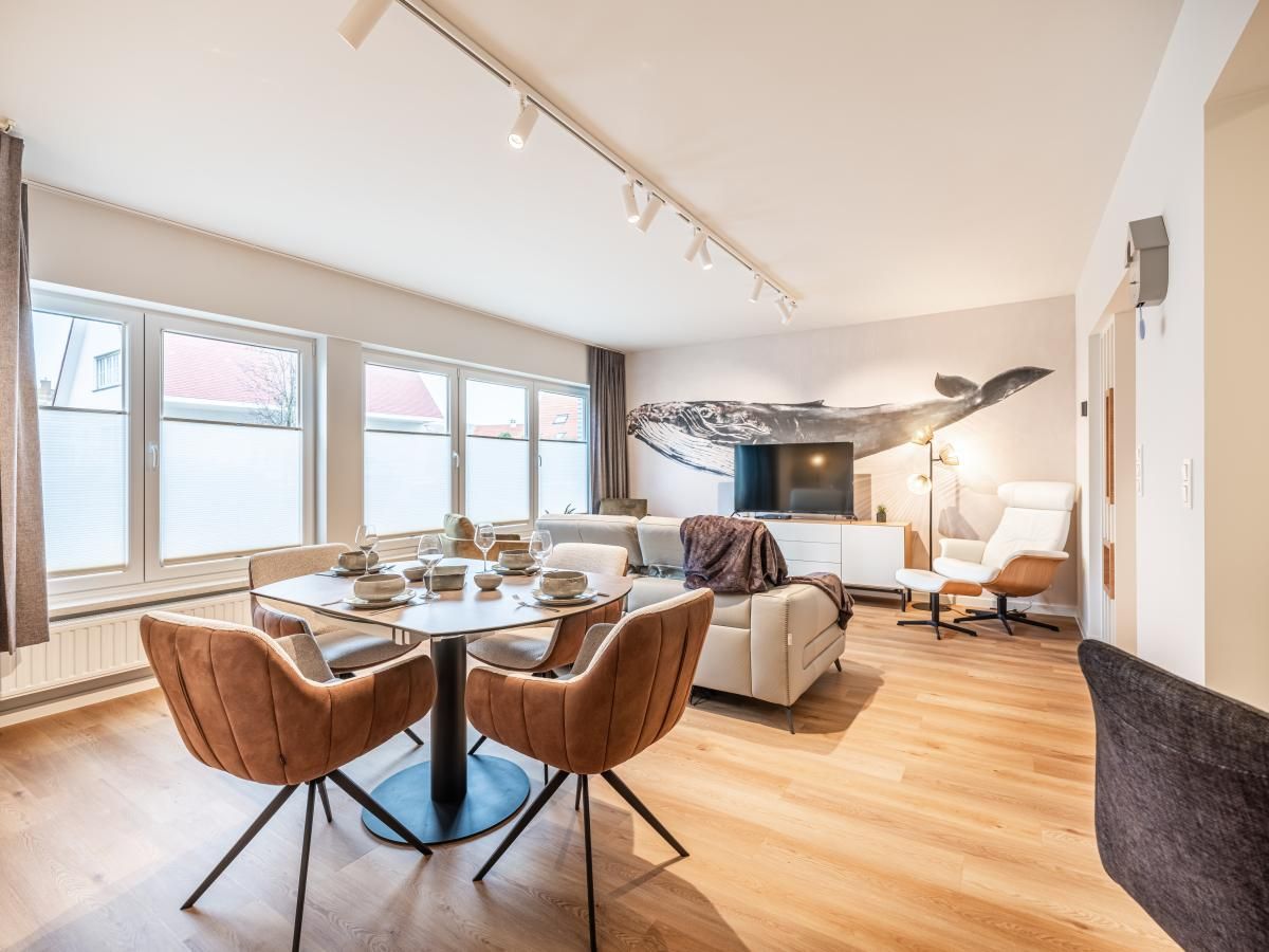 Stijlvolle woonkamer in vakantiehuis Bon Plan in Koksijde, West-Vlaanderen, met modern interieur en veel natuurlijk licht.