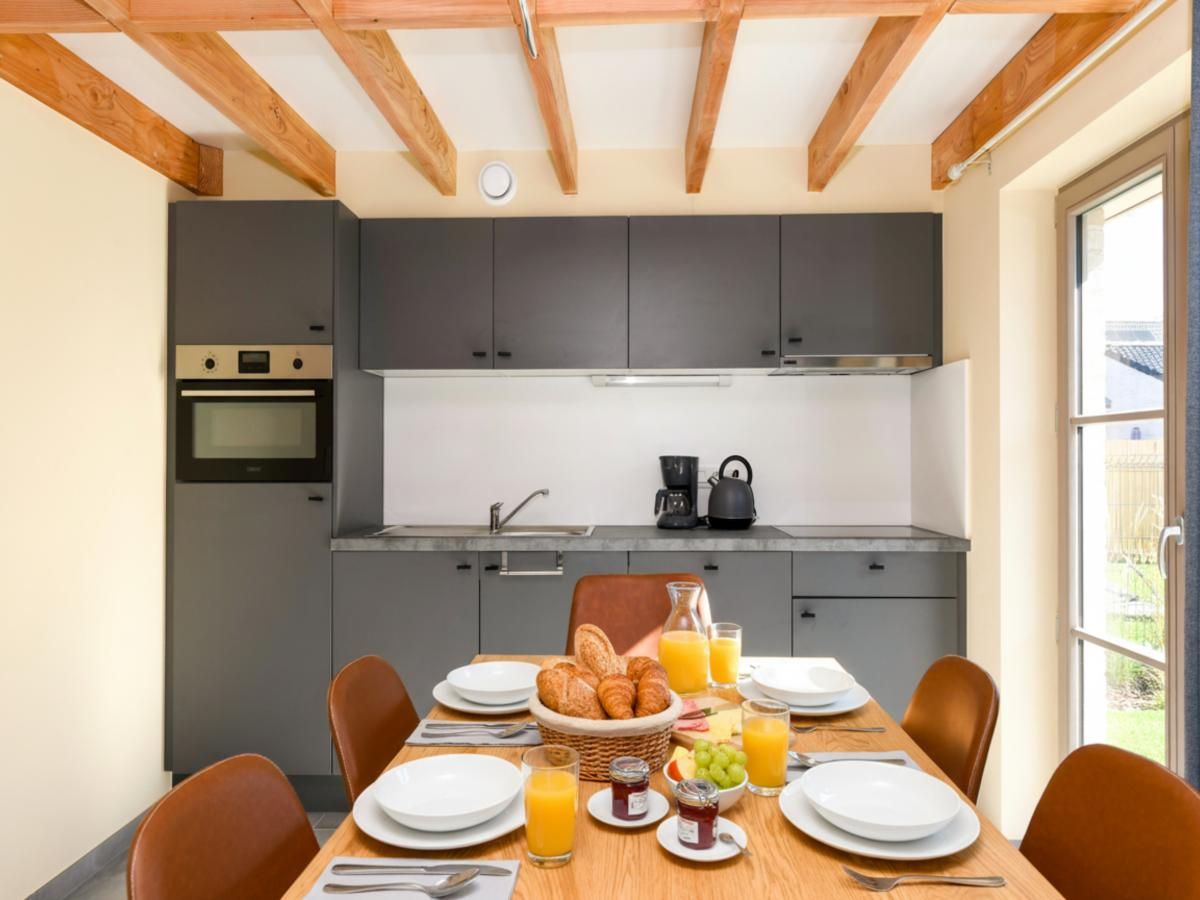 Moderne keuken in Westhinder II H54 vakantiehuis, Koksijde, met houten balkenplafond en gezellige eethoek in West-Vlaanderen, Belgie.