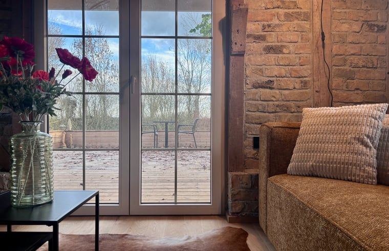 Cozy kitchen in Cottage in Alveringem, cottage in West Flanders, Belgium with rustic brick walls and modern amenities.