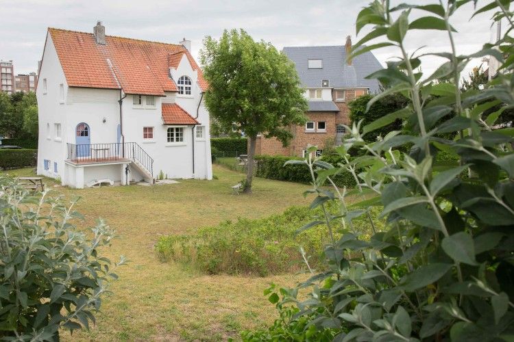 Charmevilla Westende, een sfeervol vakantiehuis in Westende, West-Vlaanderen, omgeven door groen en rustieke architectuur.