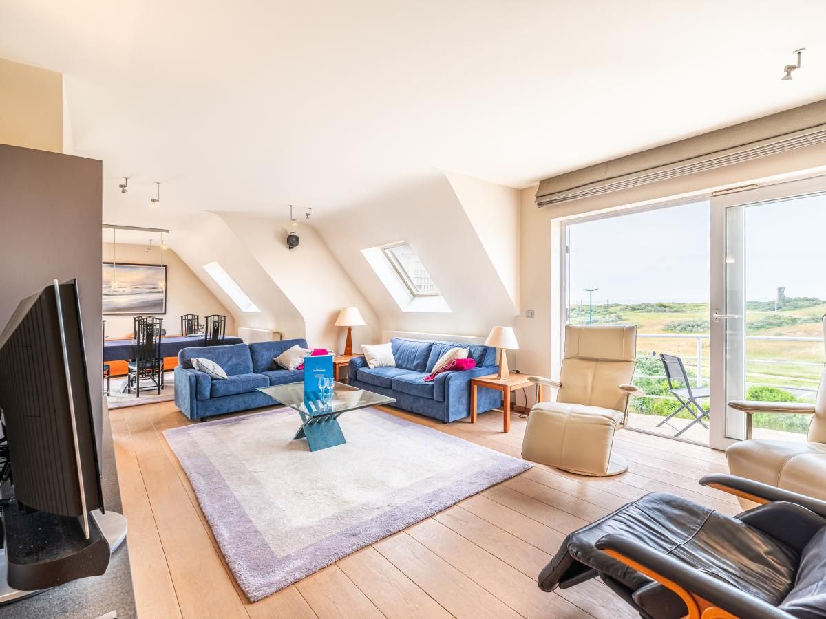 Helles Wohnzimmer des Ferienhauses LaRoyale in De Panne, Westflandern, mit komfortabler Einrichtung und Blick auf die natuerliche Umgebung.
