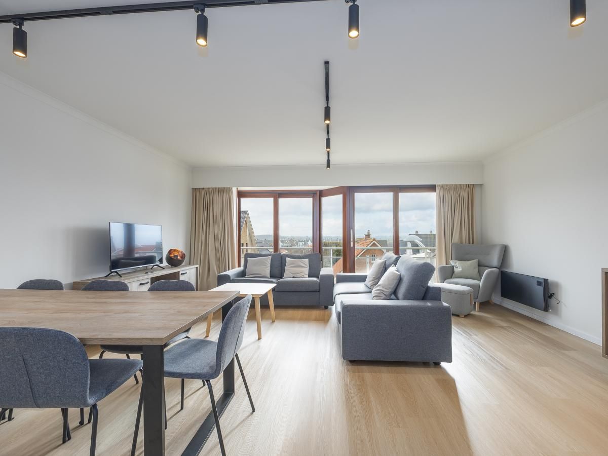 Geraeumiges Wohnzimmer des Ferienhauses "Harmony - 0301" in Middelkerke, Westflandern, mit moderner Einrichtung und Blick auf die Umgebung.