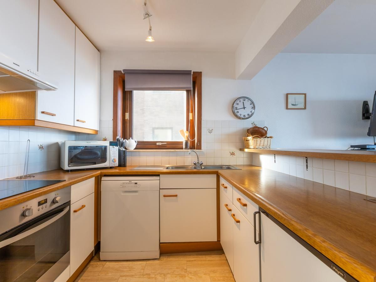 Moderne Kueche im Ferienhaus Dunekant - 0203 + park.6 in Middelkerke, Westflandern, mit Holzarbeitsplatte und reichlich Stauraum.