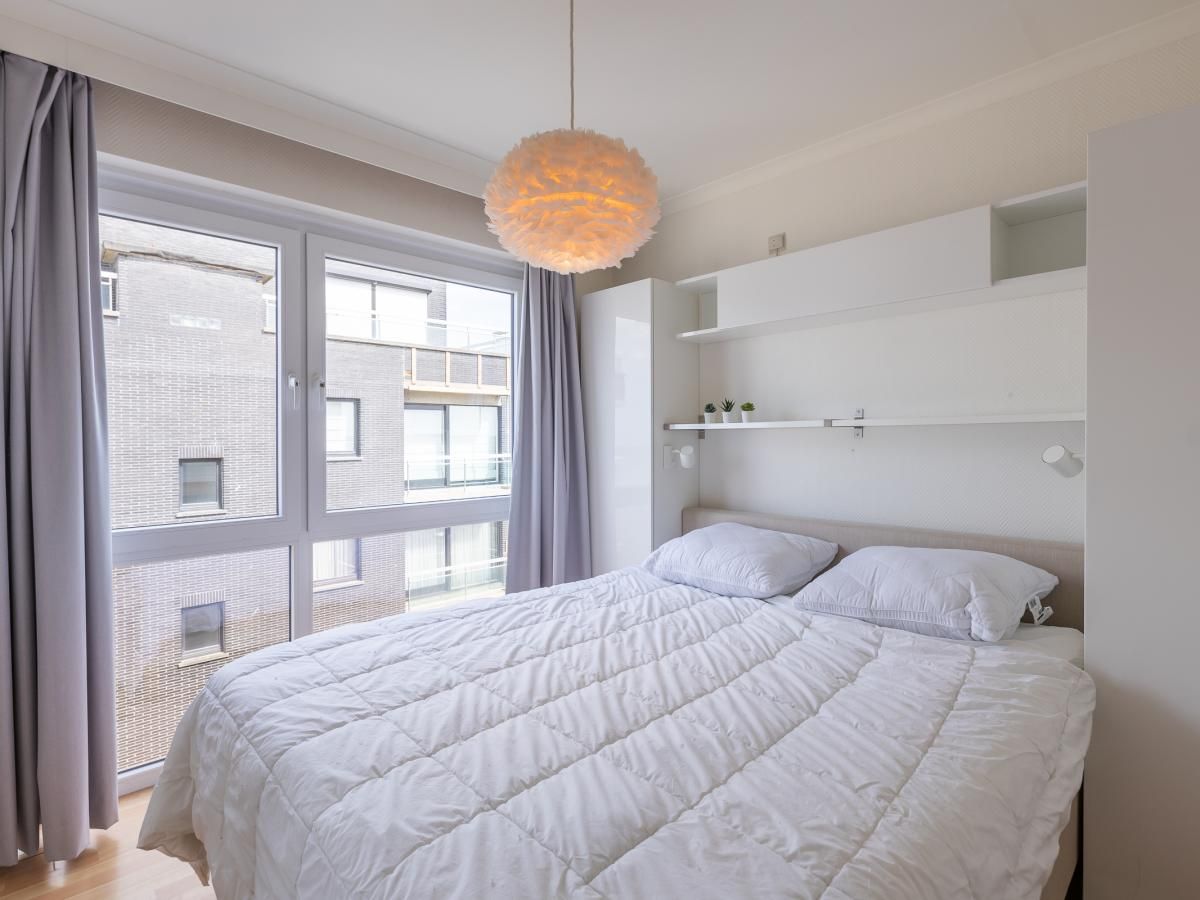 Helles Schlafzimmer im Ferienhaus Kwintebank - 0904 in Middelkerke, Westflandern, Belgien mit grossem Fenster und bequemem Doppelbett.