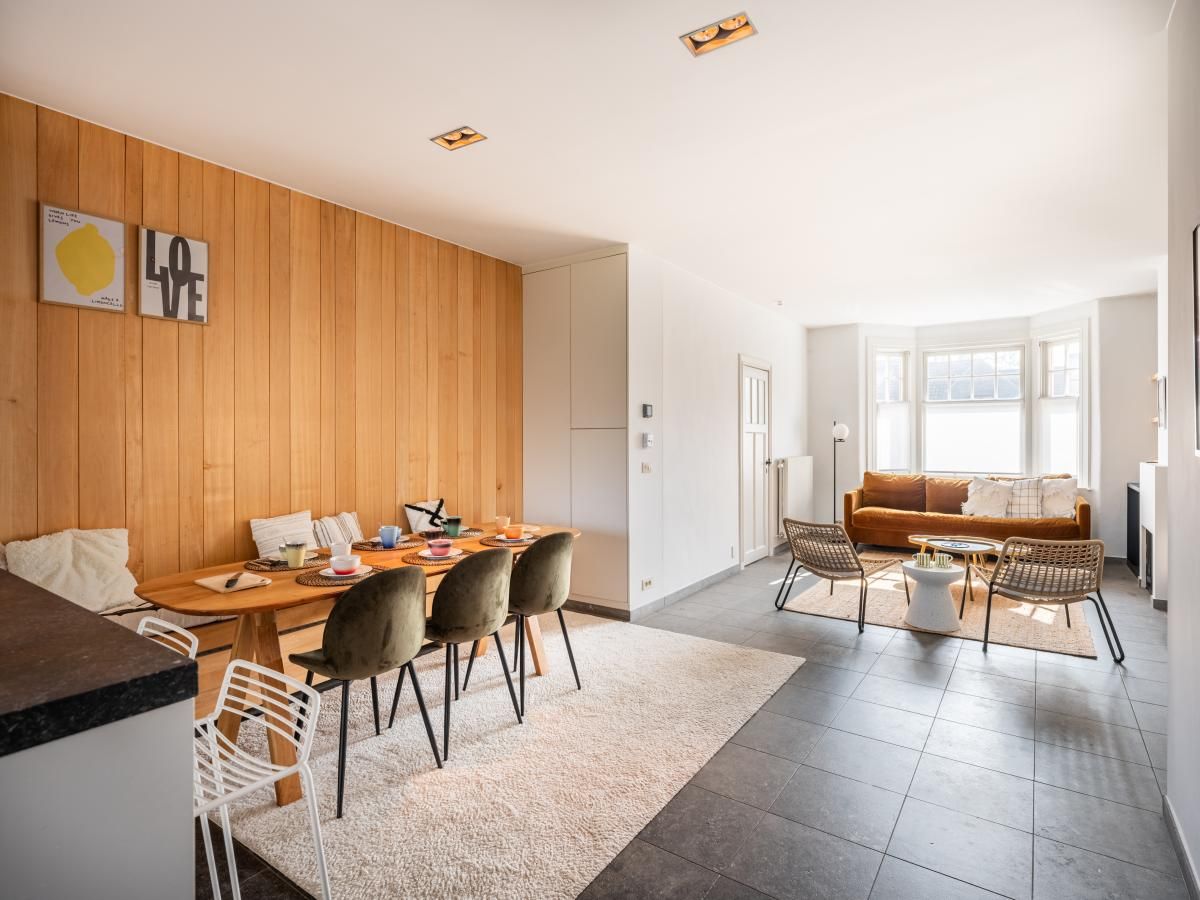 Stilvoller Innenbereich des Ferienhauses "Magique 31" in Oostduinkerke, Belgien, mit modernem Ess- und Sitzbereich.