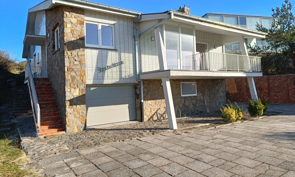 Papa's Dream vacation home in Oostduinkerke with stone facade and spacious driveway in West Flanders, Belgium.
