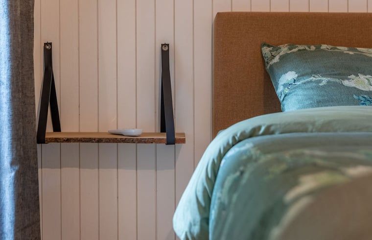 Attractive bedroom in Cottage in Merksplas, vacation home in Antwerp, with comfortable bed and rustic details.