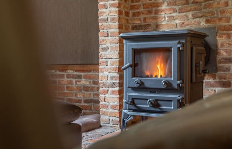 Cozy living room with wood stove in Cottage in Merksplas, vacation home in Antwerp, for cozy evenings.