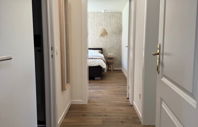 Vacation home in Merksplas, Antwerp, offers an inviting bedroom with a rustic feel for a relaxing stay.