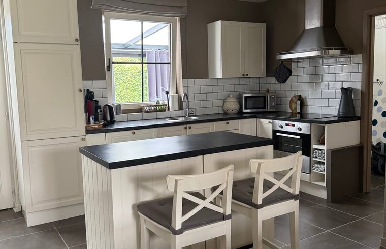 Modern kitchen in Holiday Home in Merksplas, Antwerp, Belgium, with stylish decor and lots of natural light.