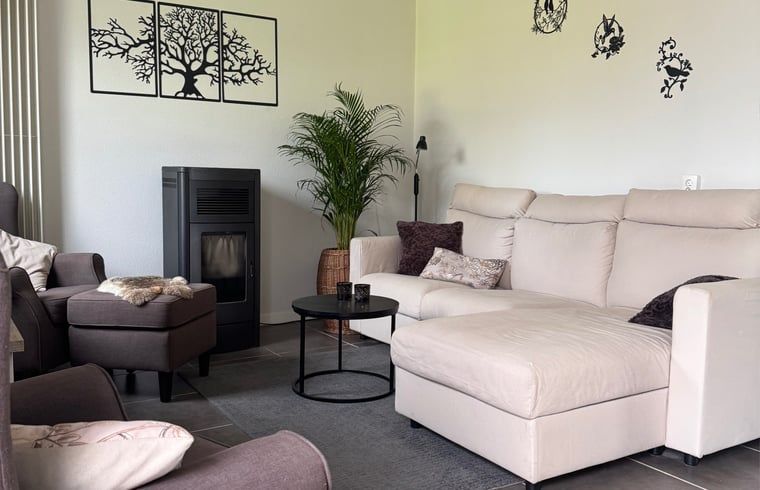 Cozy living room of Holiday Home in Merksplas, Antwerp, with comfortable sofas and modern furnishings for ultimate comfort.