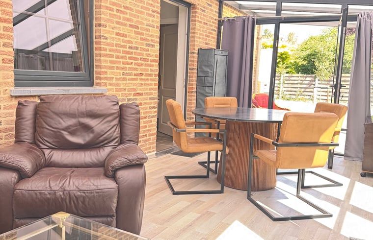 Cozy interior space of Holiday Home in Merksplas, Antwerp, with comfortable sitting area and lots of natural light.