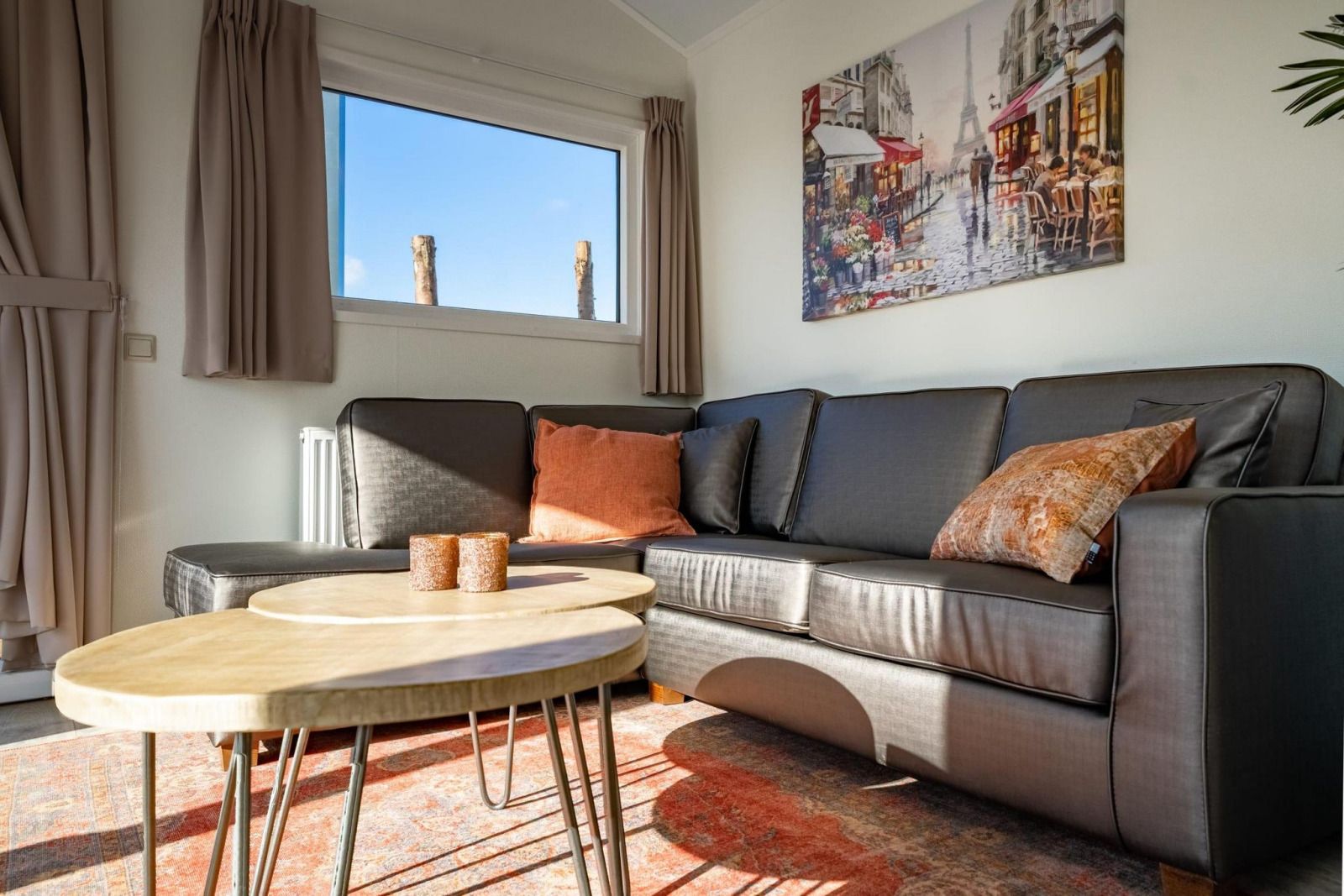 Stylish dining area in vacation home Velthorst, Mol, Antwerp with wooden table and garden view.