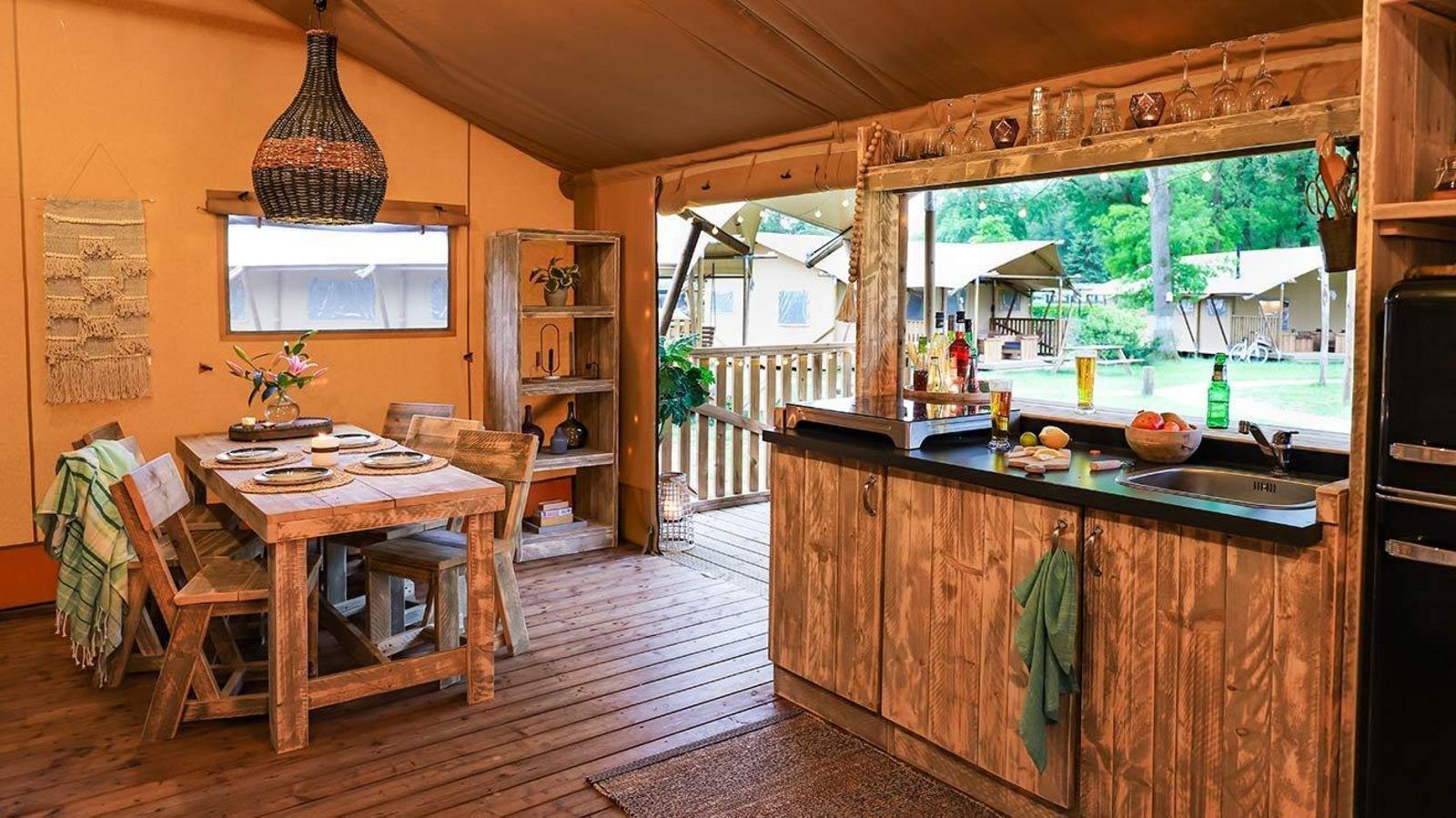 Binnenruimte van tenthuis Silver in Mol, Antwerpen, met houten interieur en uitzicht op groene natuur.