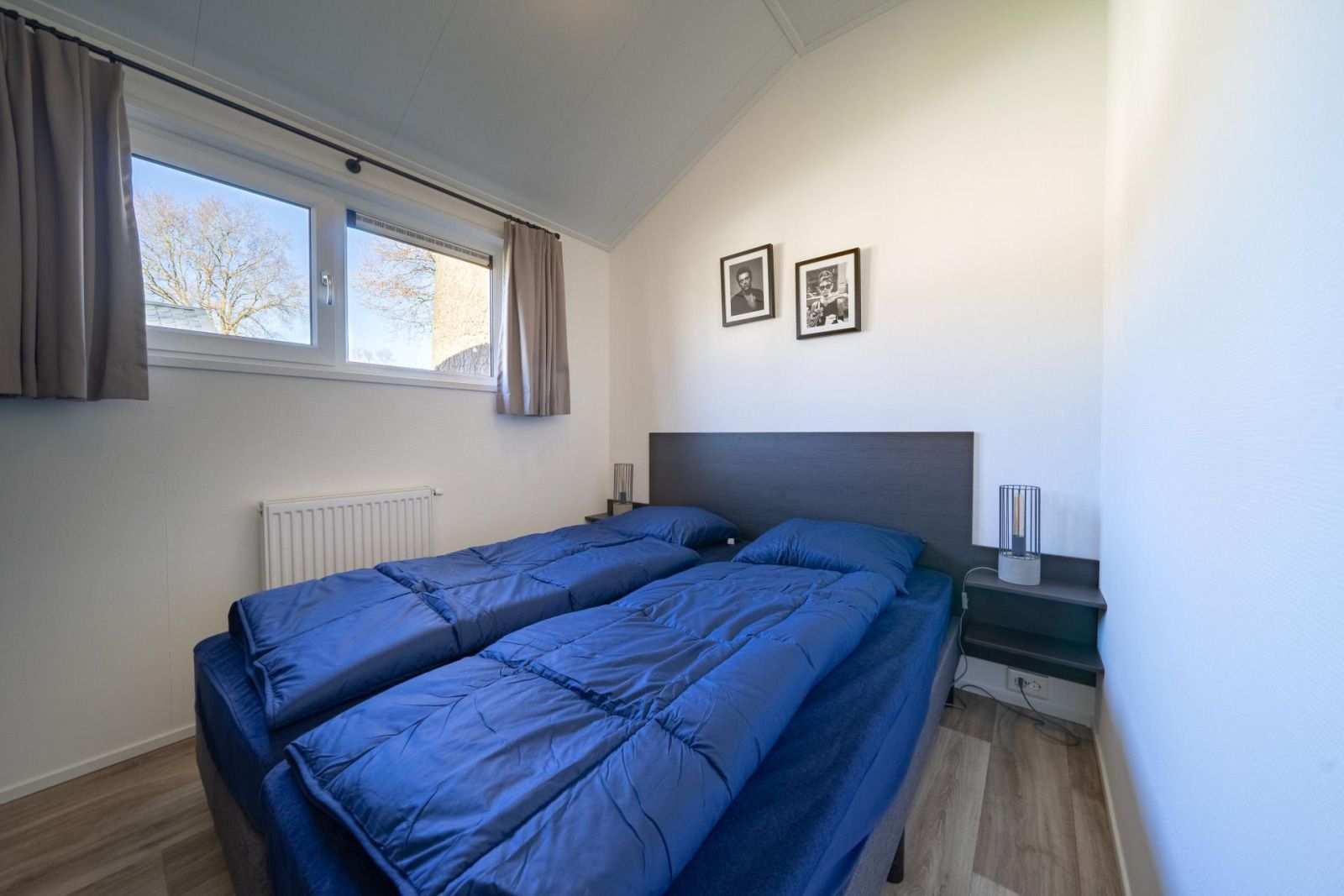 Attractive bedroom in vacation home Velthorst, Mol, Antwerp, Belgium with comfortable beds and natural light.