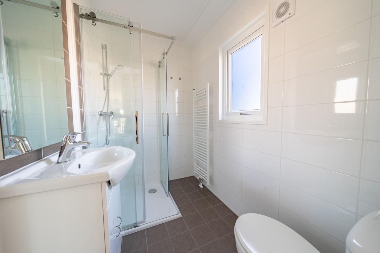 Modern bathroom in vacation home Velthorst in Mol, Antwerp, with spacious shower and bright daylight.