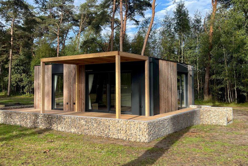 Chalet in Mol, a modern vacation home in the nature of Mol, Antwerp, with a spacious terrace and surrounded by green forests.