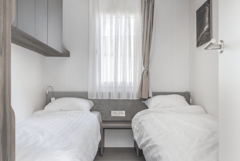 Cozy bedroom in a detached house in 2400 Mol, Antwerp, with two comfortable beds and a serene interior.