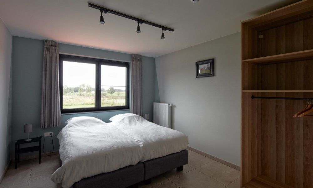 Bedroom in Driehoekshoeve vacation home Kasterlee, Antwerp overlooking the countryside.