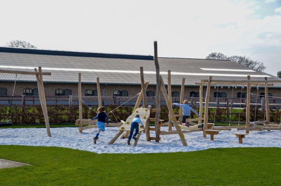 Child-friendly playground at Driehoekshoeve vacation home, Kasterlee, Antwerp with wooden play equipment.
