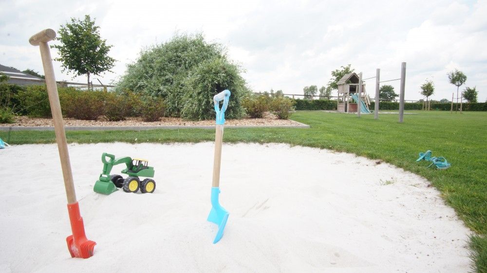 Sandbox with toys in the garden of Driehoekshoeve vacation home, Kasterlee, Antwerp.