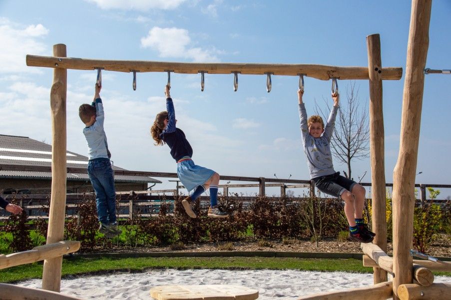 Children play on climbing apparatus at Driehoekshoeve vacation home in Kasterlee, Antwerp.
