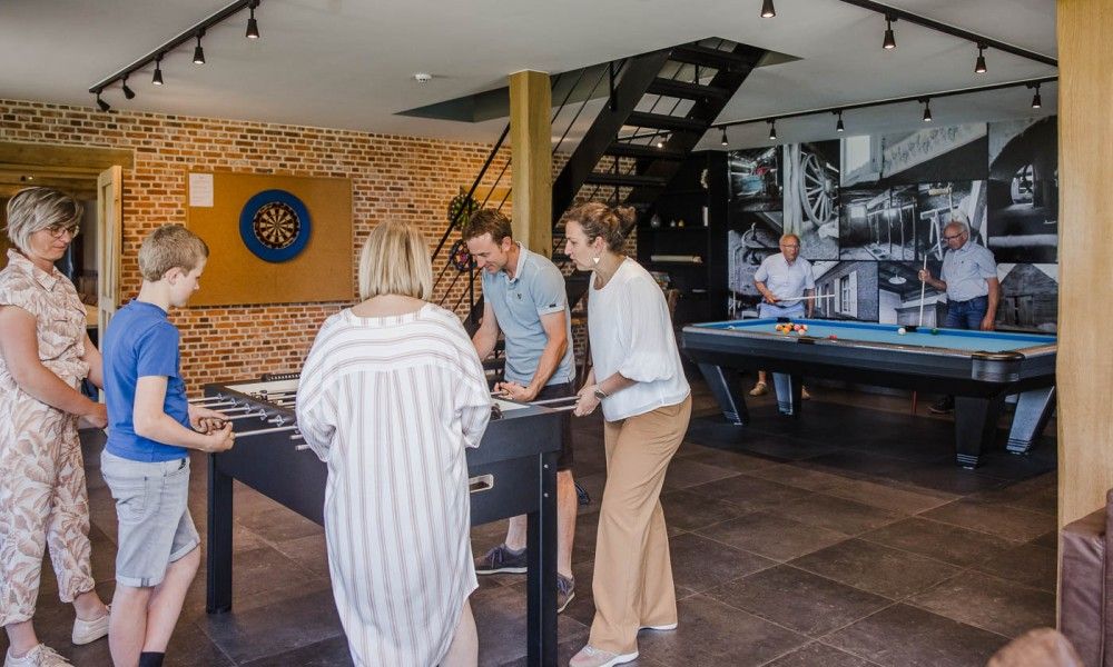 Game room with table soccer and dartboard in Driehoekshoeve vacation home, Kasterlee, Antwerp.
