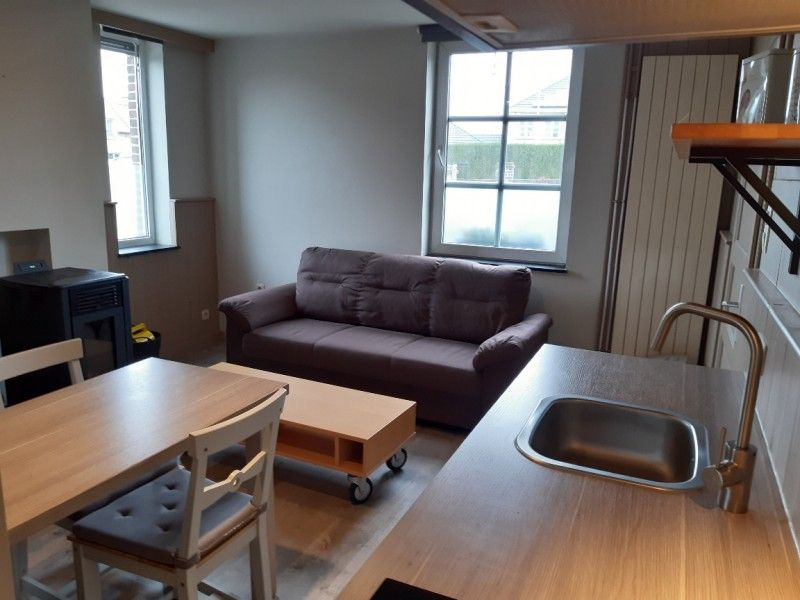 Gezellige hoek met pelletkachel in Aan Maas & Grens vakantiehuis in Kinrooi, Limburg, Belgie.
