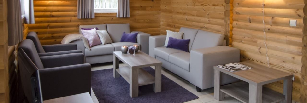 Gezellige woonkamer in Mooi Zutendaal 6-persoons bungalow 6C1, Zutendaal, Limburg, met comfortabele banken en houten interieur.