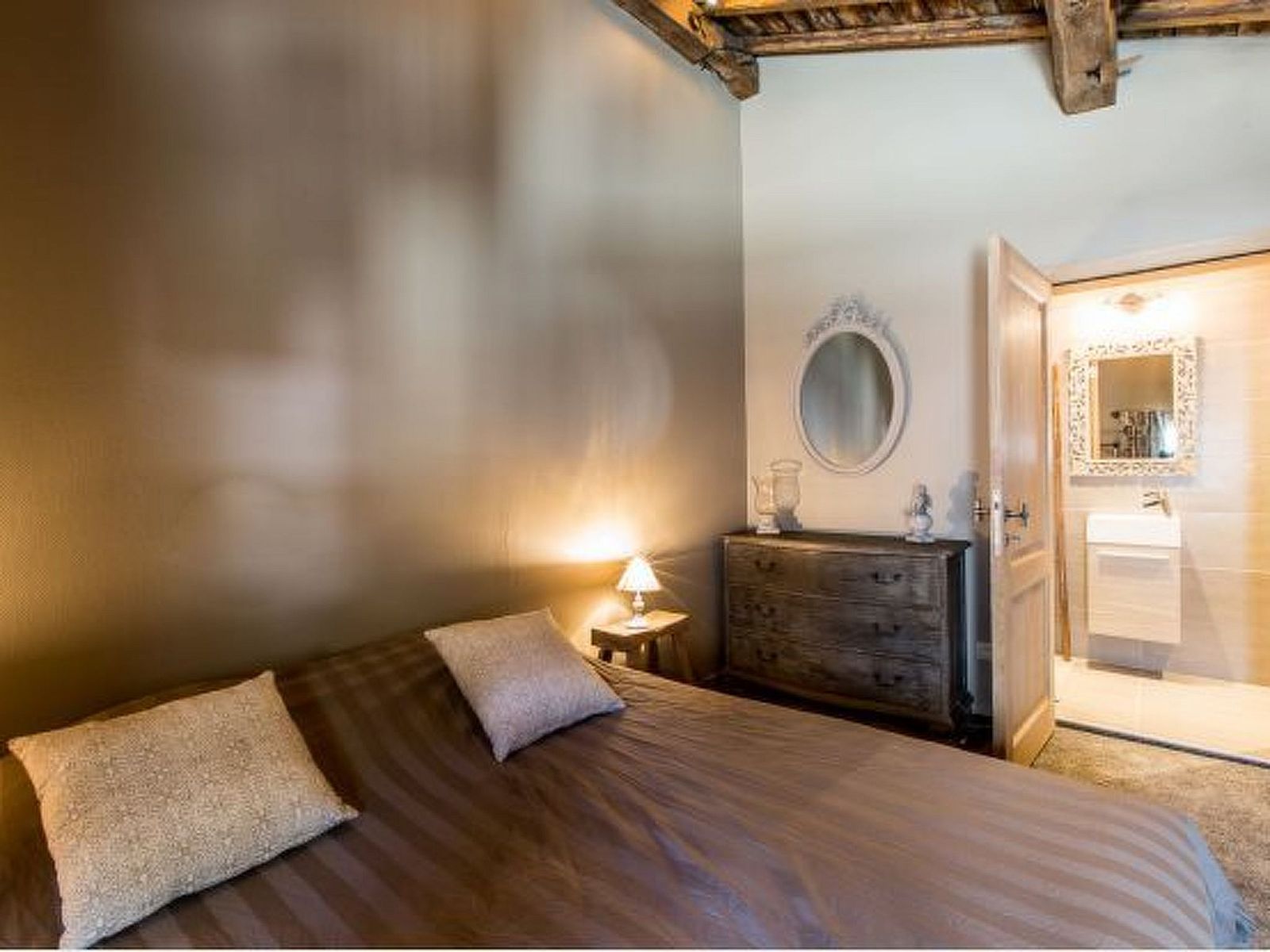 Cozy bedroom in Holiday Home Villa 'Marie France' Wellness, Stavelot, Ardennes, Belgium, with rustic interior and warm lighting.