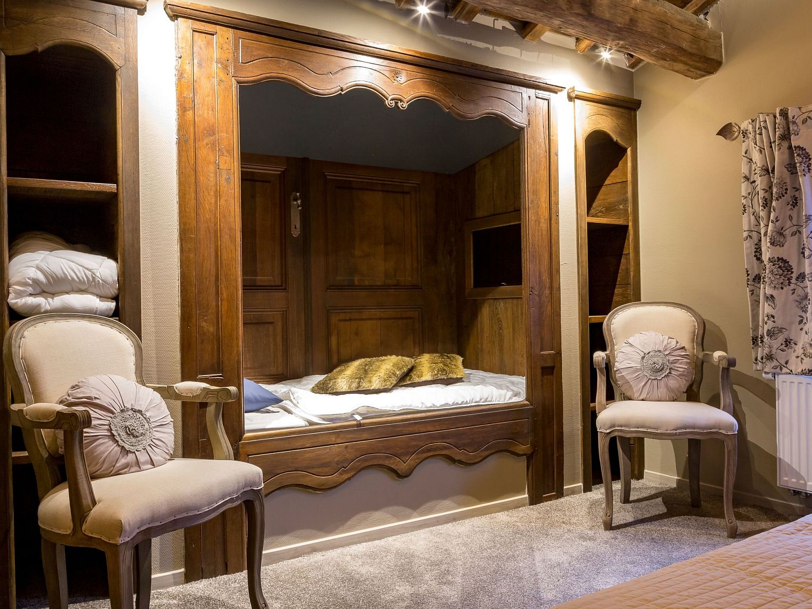 Cozy bedroom in Holiday Home Villa 'Marie France' Wellness, Stavelot, Ardennes, with authentic wooden bed and elegant chairs.