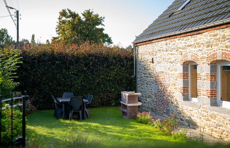 Enjoy the tranquility of the garden of Holiday Home in Sivry, Hainaut, Belgium, with a charming stone terrace and green surroundings.
