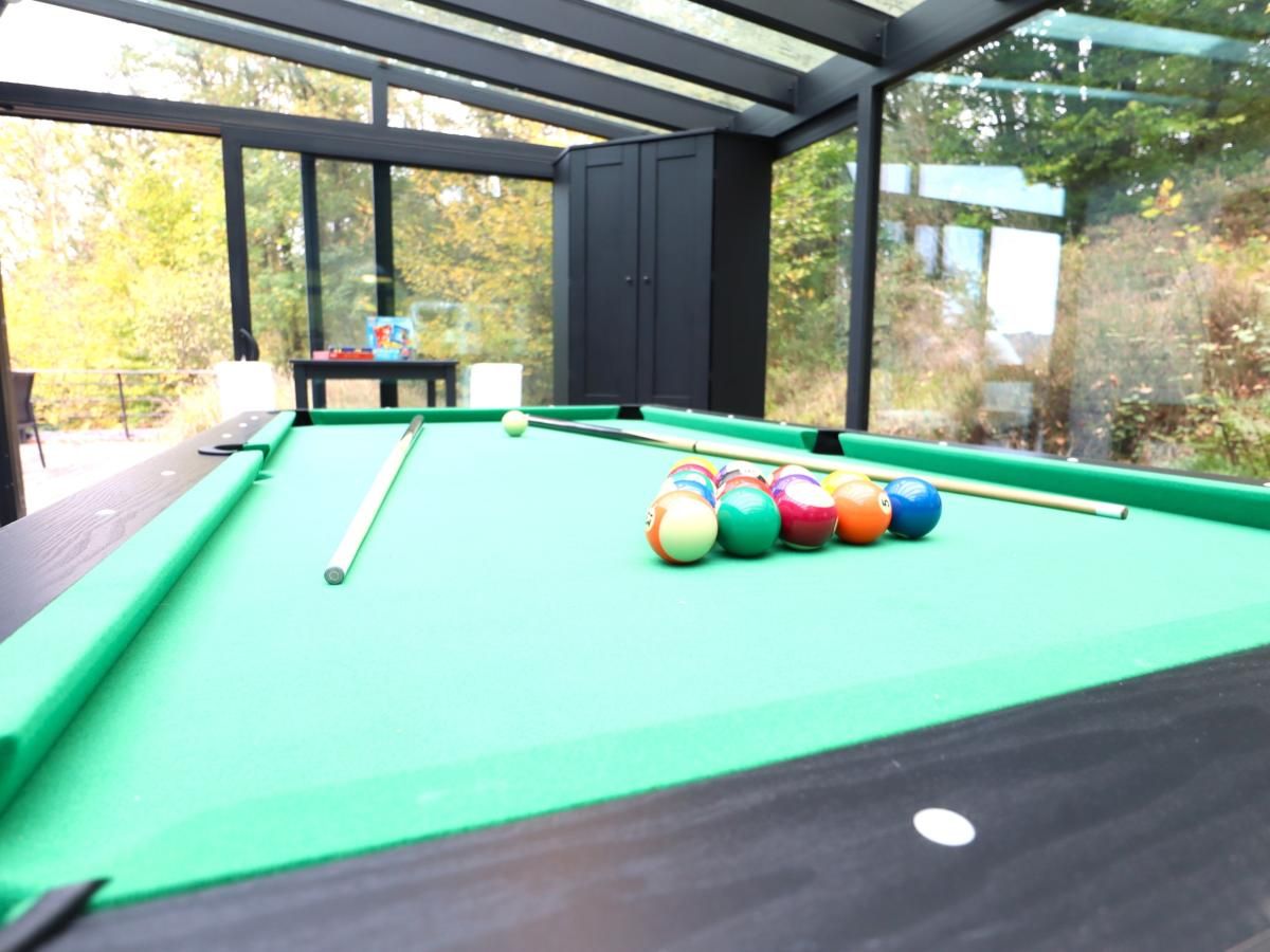 Enjoy relaxation at chalet Agathe in Laforet, Ardennes, with a pool table in the bright indoor space surrounded by nature.