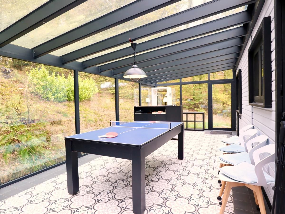 Enjoy relaxation and games at Chalet Agathe, Laforet, Ardennes. Bright indoor space with ping pong table and views of nature.
