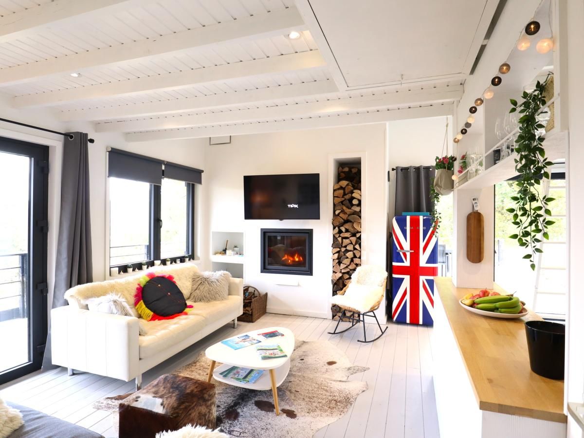 Cozy living room in Chalet Agathe, Laforet, Ardennes. Modern decor with fireplace and views of nature in Belgium.