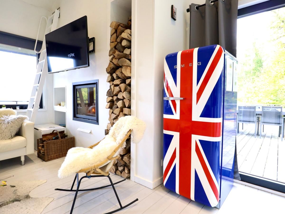 Stylish interior of chalet Agathe in Laforet, Ardennes, with unique British design and terrace views.