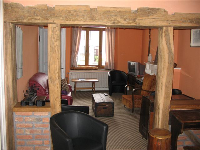 Authentic living room in L'Odasse, vacation home Bohan, Ardennes, with wooden beams and cozy decor.