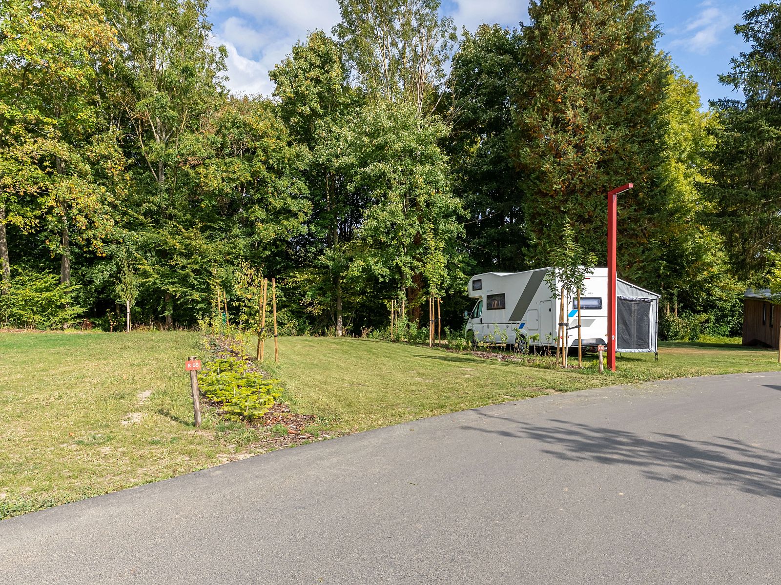 Luxe kampeerplaats C1 in Gesves, Ardennen, Belgie, omringd door groene natuur en rustige omgeving, perfect voor een ontspannen verblijf.