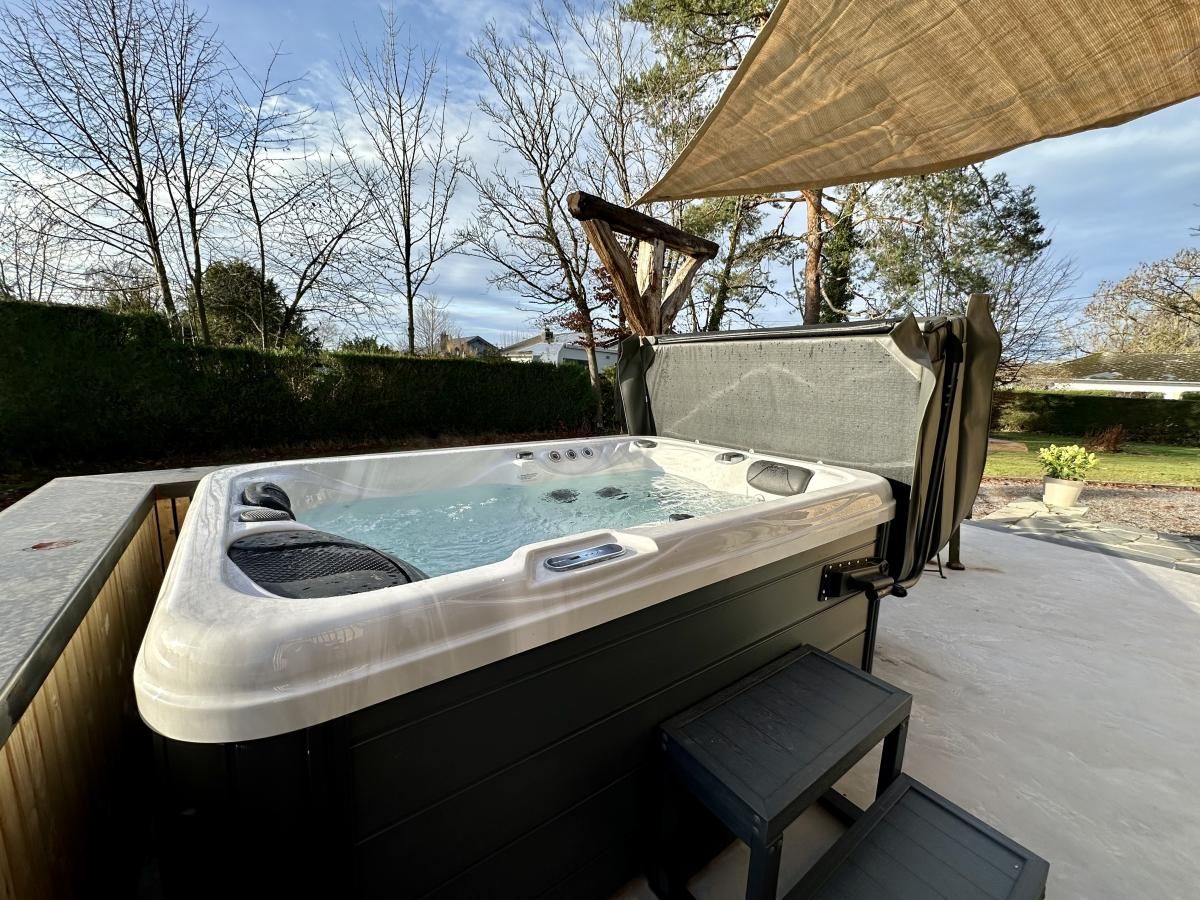 Enjoy the luxurious jacuzzi on the terrace of Chez Brigitte, a vacation home in Durbuy, surrounded by the nature of the Ardennes, Belgium.