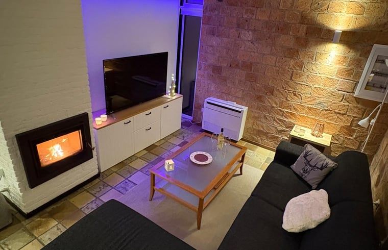 Cozy living room in Cottage in Izier, Ardennes with cozy fireplace and modern decor, ideal for relaxation in Luxembourg, Belgium.