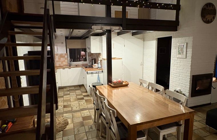 Cozy indoor area of Holiday Home in Izier, Ardennes, with spacious dining table and modern kitchen for a comfortable stay.