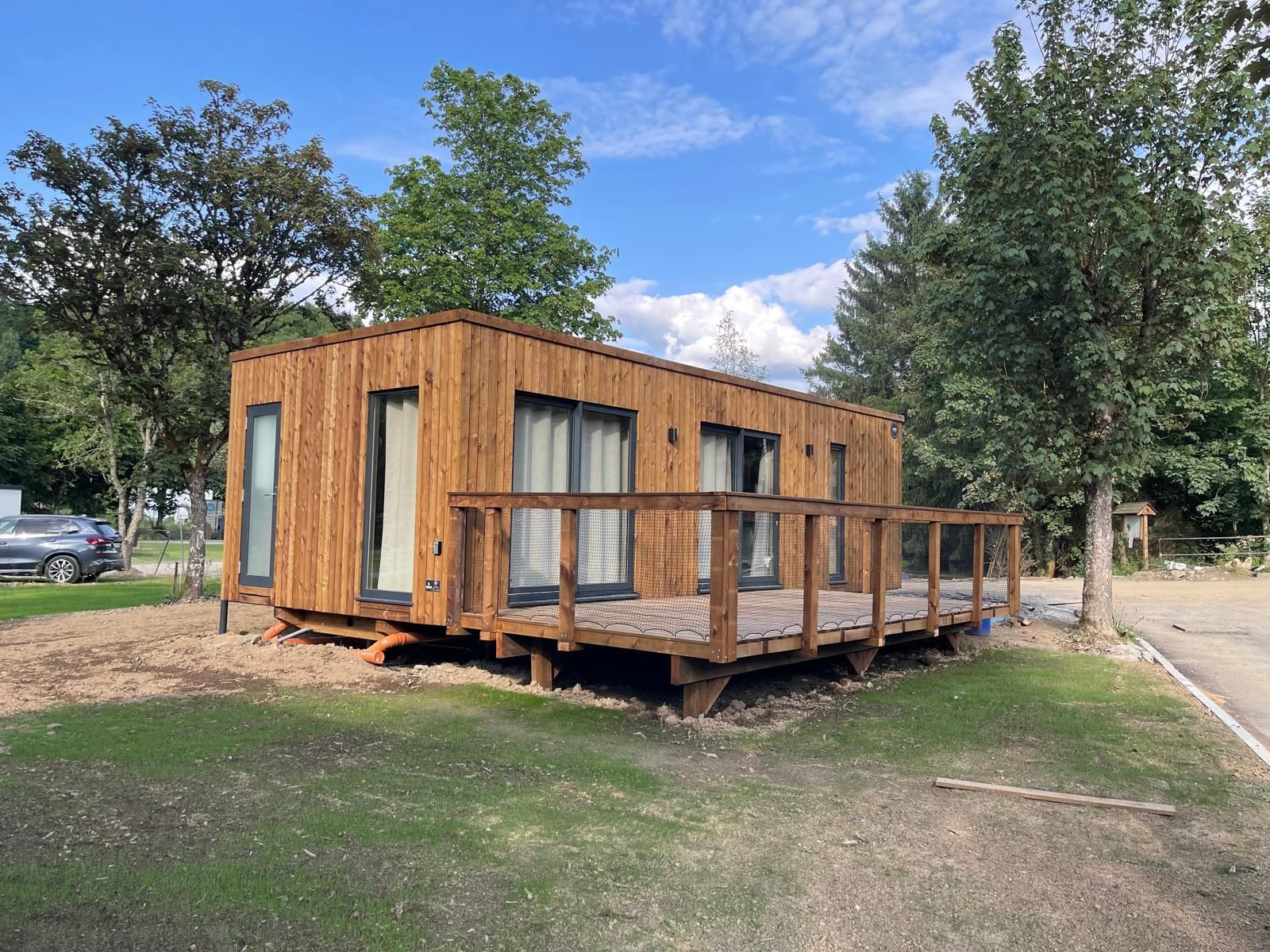 Ecolodge vacation home in Houffalize, Ardennes, Belgium with wooden terrace and surrounded by nature.