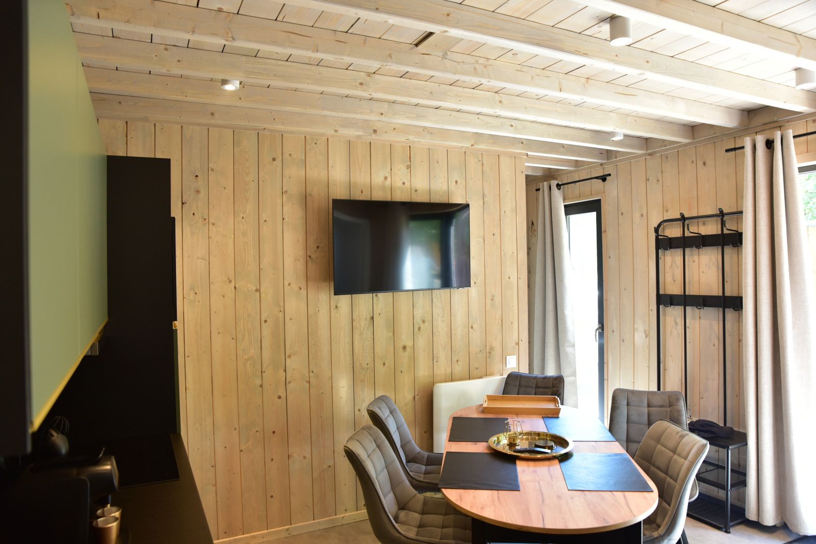 Cozy interior of Ecolodge vacation home in Houffalize, Ardennes, with wooden interior and modern amenities.