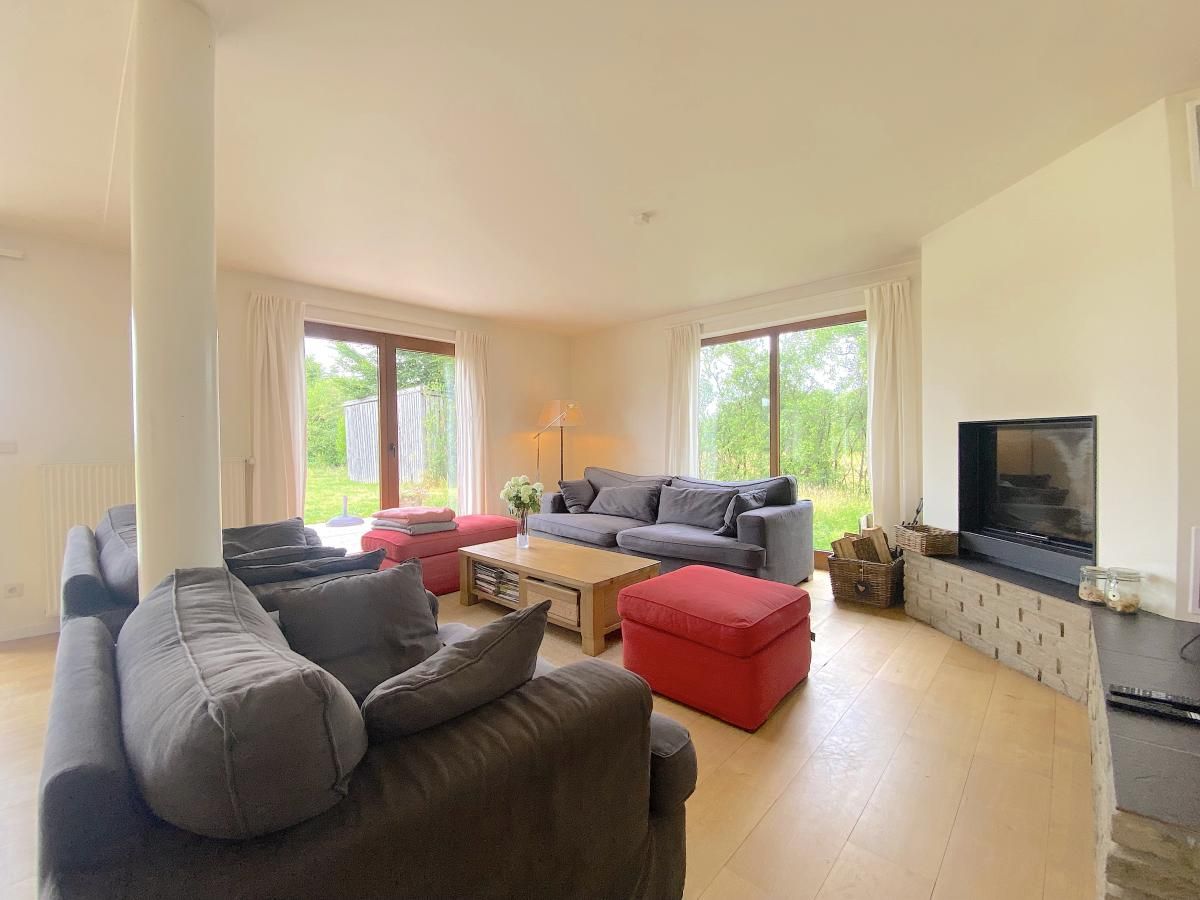 Cozy living room with comfortable seating area in Holiday Home Wilogne, perfect for family time.